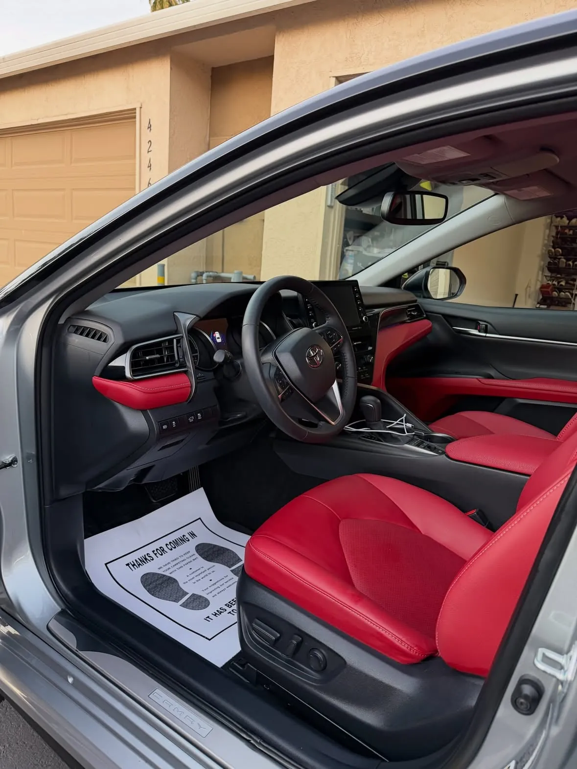 Red leather interior of a Toyota Camry after a detail