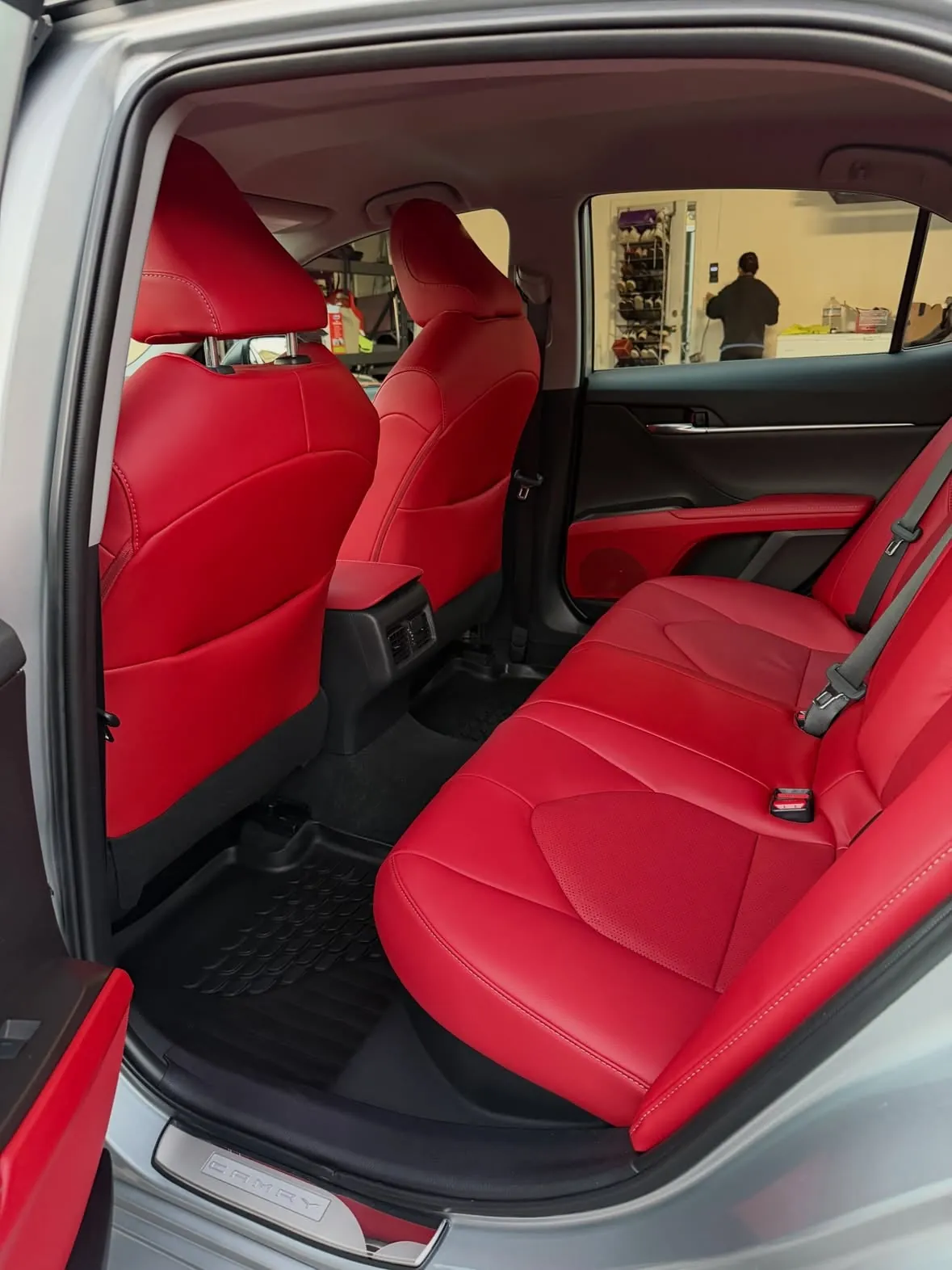 Red leather rear seat of a Toyota Camry after a detail