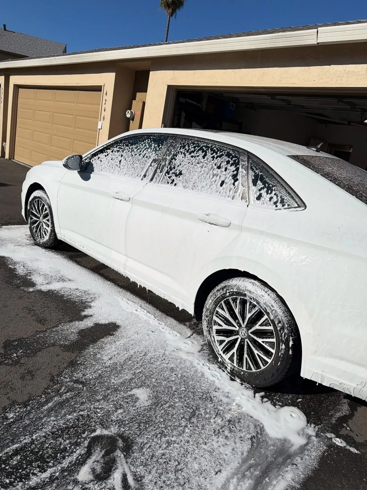 White Volkswagen Jetta covered in thick foam