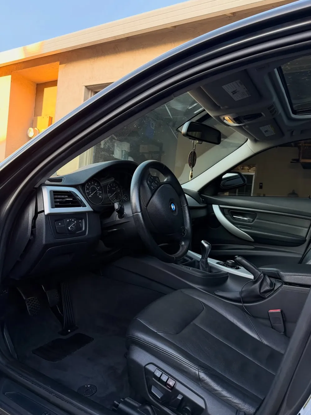 The same BMW 328i front seats and floor clean after a Premium Detail