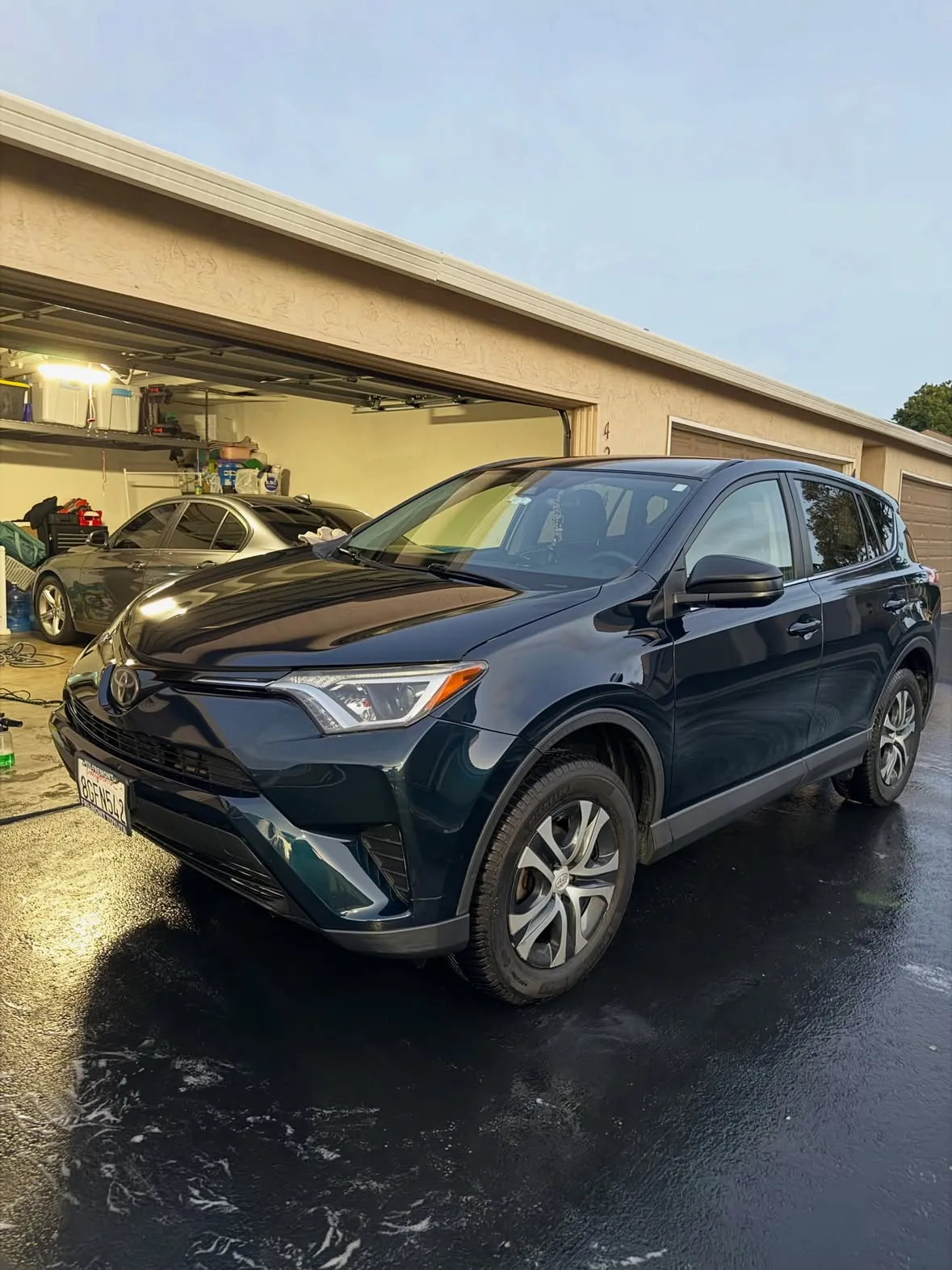 Dark Toyota RAV4 rinsed and shining in the driveway in Union City