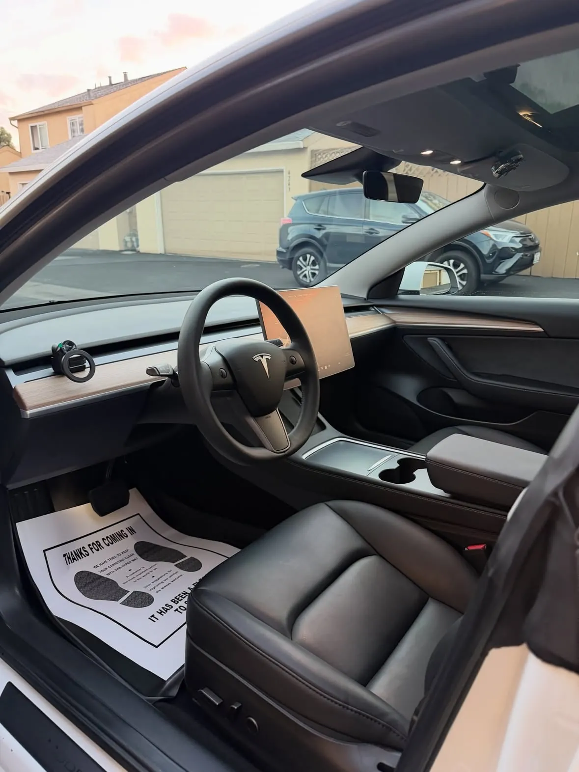 Clean front interior of a Tesla Model 3 after a detail