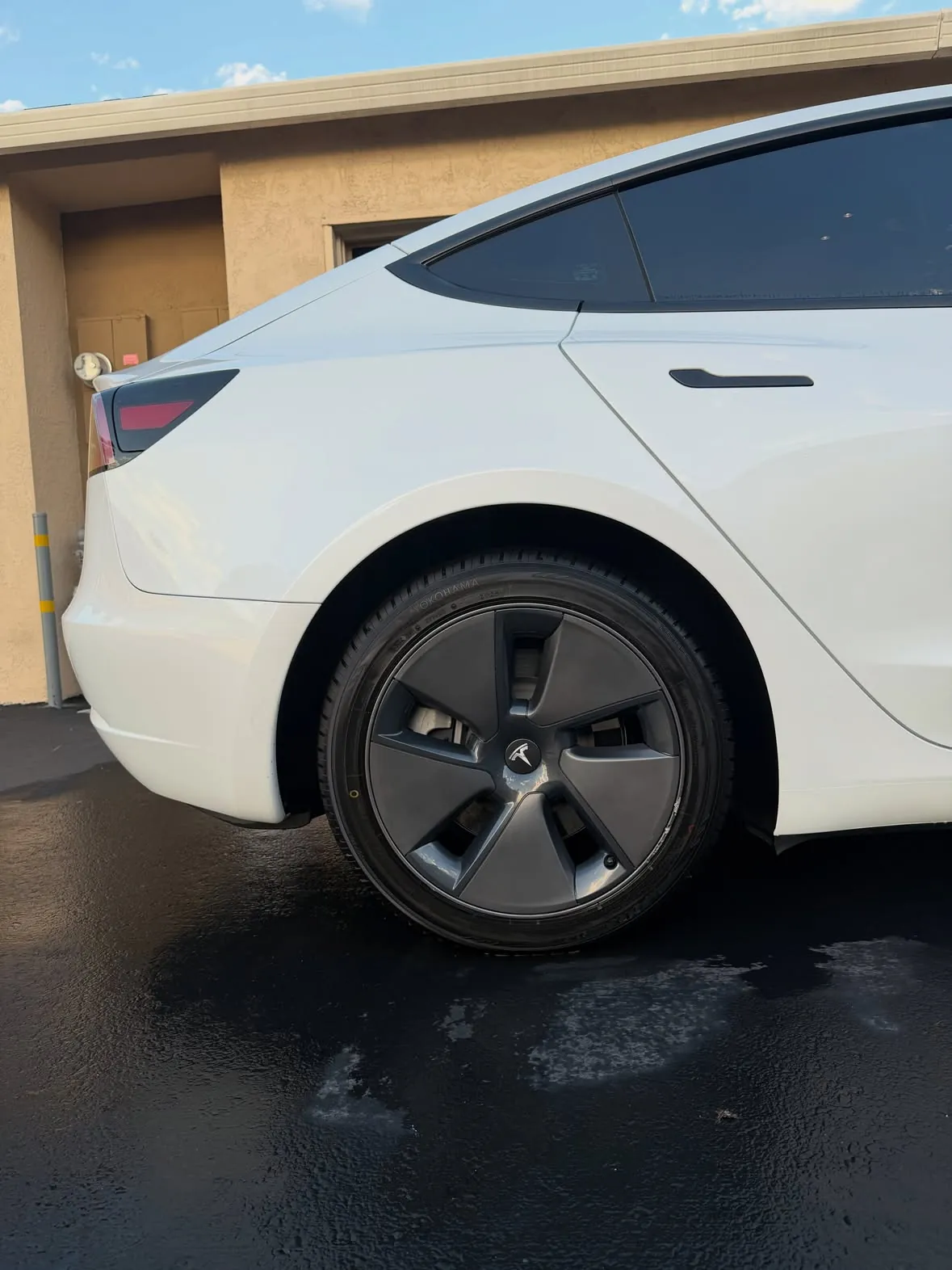 Side view of a clean white Tesla Model 3